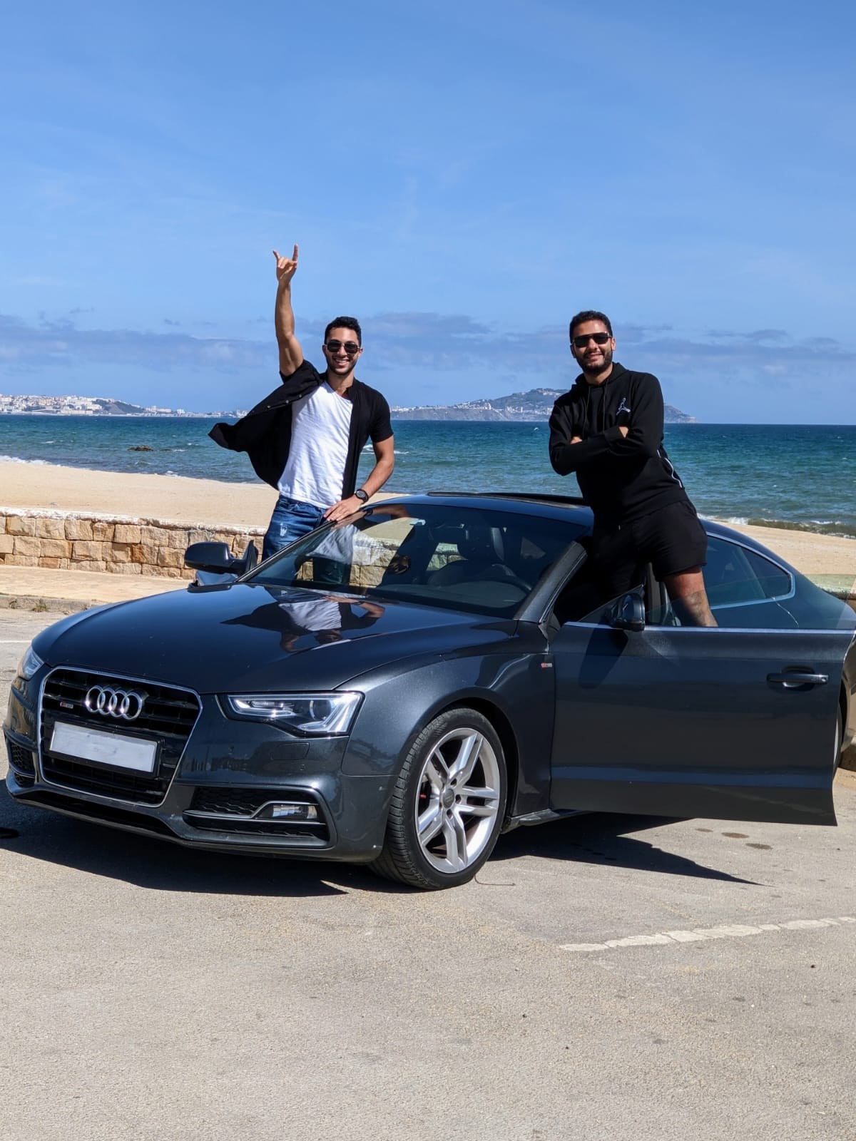Nabil Berrada and Mehdi Hilalou beside their car